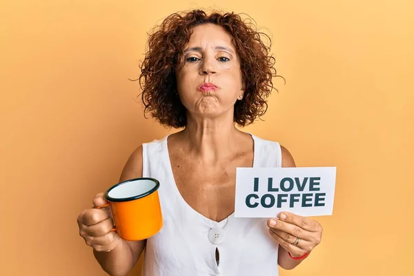 Beautiful Middle Age Mature Woman Holding Love Coffee Banner Puffing — Fotografia de Stock