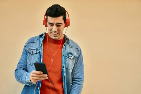Junger Hispanischer Mann Lächelt Glücklich Mit Smartphone Und Kopfhörer Die — Stockfoto
