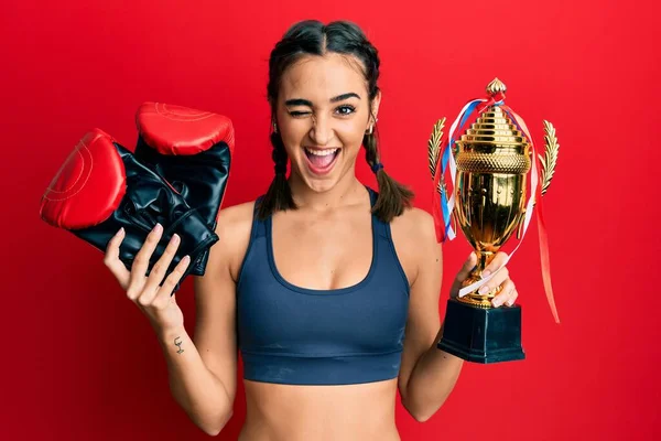Young Brunette Girl Holding Boxer Gloves Trophy Winking Looking Camera — Stockfoto