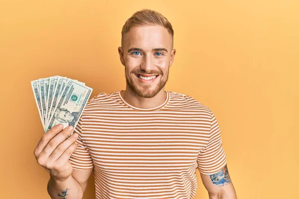 Young Caucasian Man Holding Dollars Looking Positive Happy Standing Smiling — Stock Photo, Image