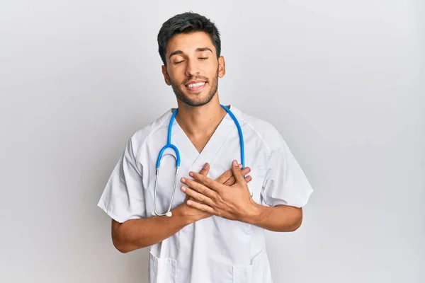 Young Handsome Man Wearing Doctor Uniform Stethoscope Smiling Hands Chest — Stock Photo, Image