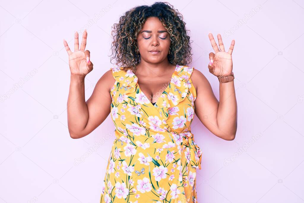 Young african american plus size woman wearing casual clothes relax and smiling with eyes closed doing meditation gesture with fingers. yoga concept. 