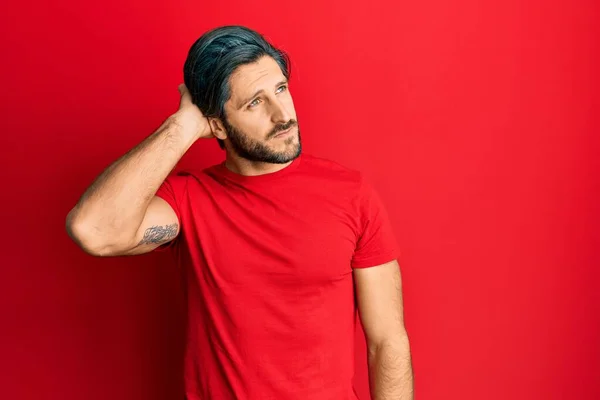 Young Hispanic Man Wearing Casual Red Shirt Confuse Wondering Question — Fotografia de Stock