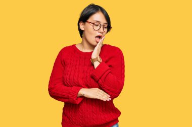 Kısa saçlı, sıradan süveter giyen ve gözlüklü, esnemekten sıkılmış, ağzı eliyle kapatan genç, güzel İspanyol bir kadın. Huzursuz ve uykulu.. 