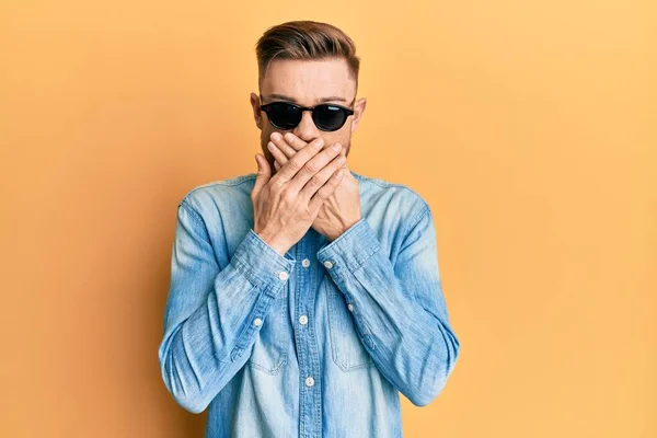 Young Redhead Man Wearing Stylish Sunglasses Shocked Covering Mouth Hands — Stok fotoğraf