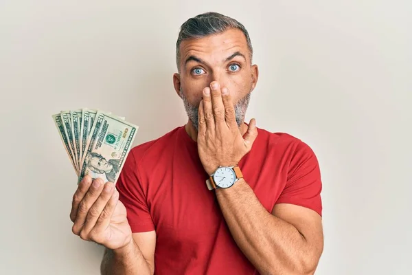 Middle Age Handsome Man Holding Dollars Banknotes Covering Mouth Hand — ストック写真