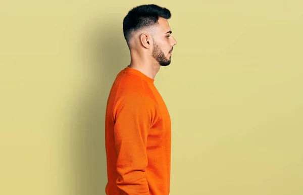 오렌지색 스웨터를 바라보며 긴장을 자신감 미소를 얼굴을 스페인 — 스톡 사진