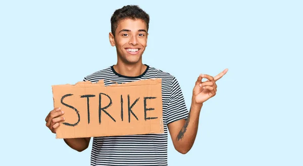 Young Handsome African American Man Holding Strike Banner Cardboard Smiling — Stock Photo, Image