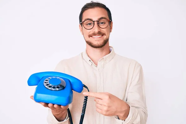 Young Handsome Man Holding Vintage Telephone Smiling Happy Pointing Hand — ストック写真