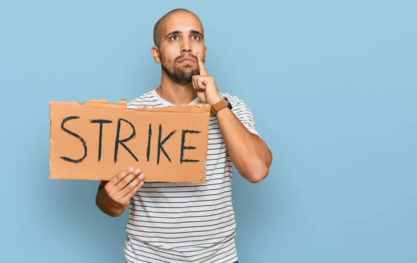 Hispanic Adult Man Holding Strike Banner Cardboard Serious Face Thinking — Stock Photo, Image