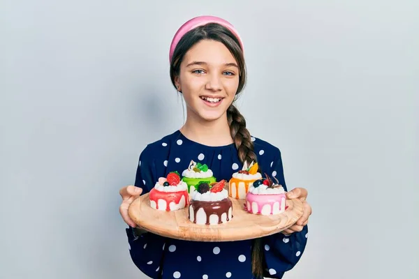Young Brunette Girl Holding Sweet Pastries Smiling Laughing Hard Out — 스톡 사진