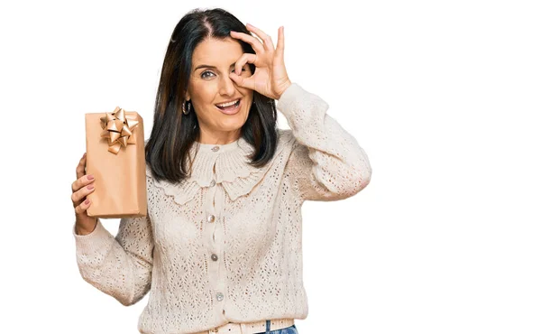 Middle Age Brunette Woman Holding Gift Smiling Happy Doing Sign — Stock Photo, Image