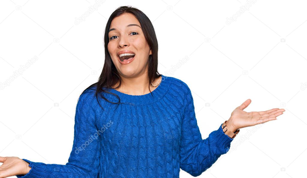 Young hispanic woman wearing casual clothes clueless and confused expression with arms and hands raised. doubt concept. 