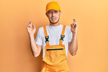 Tamirci üniforması giyen İspanyol genç adam umut ve gözlerin kapalı gülümseyerek bana işaret etti. Şans ve batıl inançlar. 