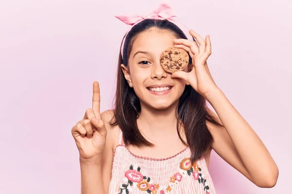 Beautiful Child Girl Holding Cookie Smiling Idea Question Pointing Finger — 스톡 사진