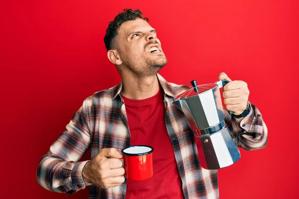 Young Hispanic Man Drinking Italian Coffee Angry Mad Screaming Frustrated — Stock Photo, Image