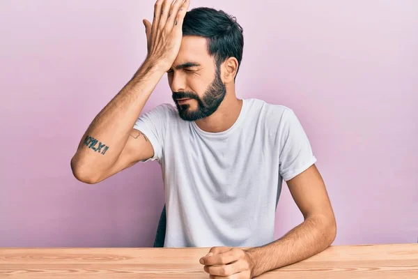 Young Hispanic Man Wearing Casual Clothes Sitting Table Surprised Hand — Stock Photo, Image