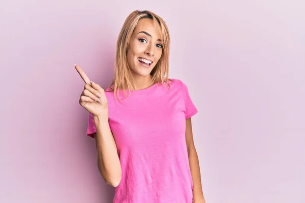 Mooie Blonde Vrouw Draagt Casual Roze Tshirt Wijzen Vinger Omhoog — Stockfoto