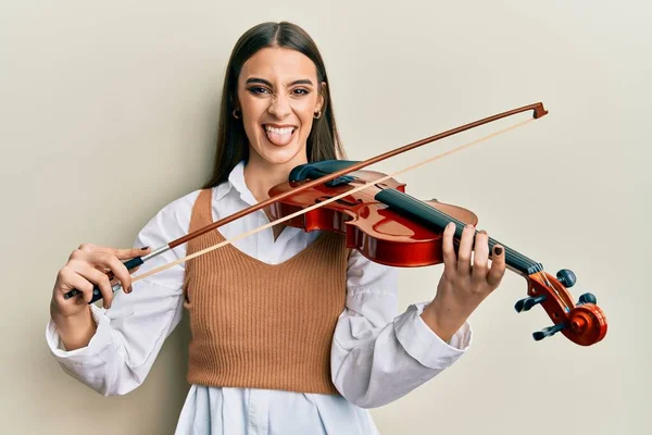 Beautiful Brunette Young Woman Playing Violin Sticking Tongue Out Happy — Stock Photo, Image