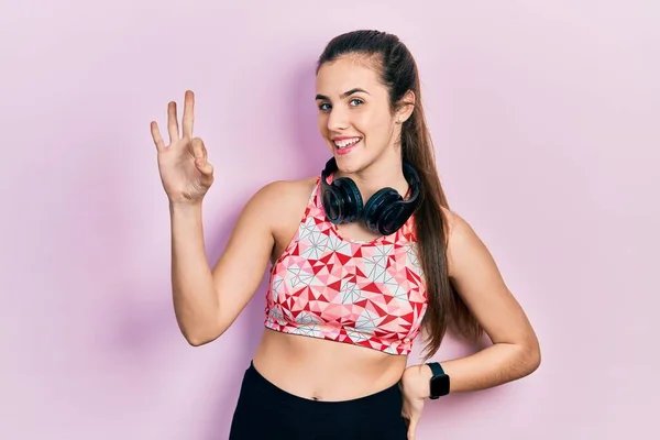 Young Brunette Teenager Wearing Gym Clothes Using Headphones Smiling Positive — 스톡 사진