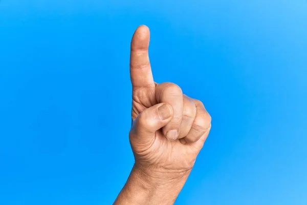 Hand Van Senior Spaanse Man Blauw Geïsoleerde Achtergrond Tellen Nummer — Stockfoto