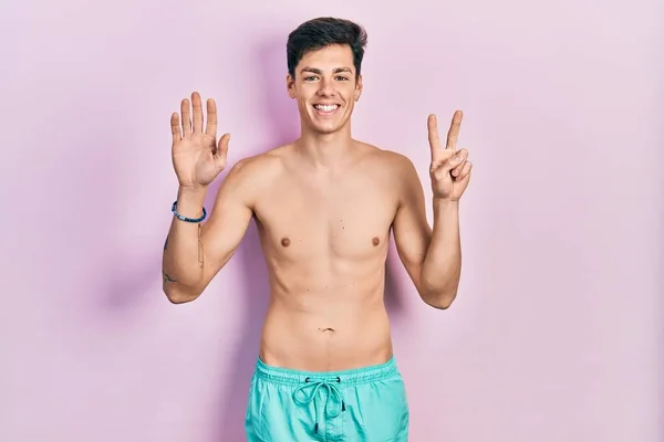 Young Hispanic Man Wearing Swimwear Shirtless Showing Pointing Fingers Number — Stock Photo, Image