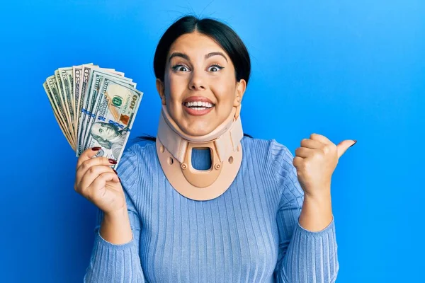 Beautiful Brunette Woman Wearing Cervical Collar Holding Insurance Money Pointing — Stock Photo, Image
