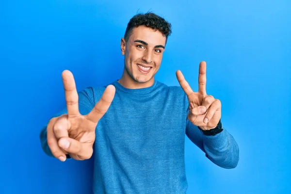 Jovem Hispânico Vestindo Camisola Inverno Casual Sorrindo Com Língua Para — Fotografia de Stock