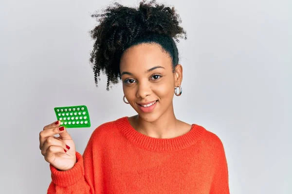 Niña Afroamericana Joven Sosteniendo Píldoras Anticonceptivas Con Aspecto Positivo Feliz — Foto de Stock