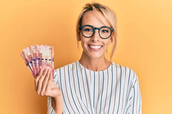 Beautiful Blonde Woman Holding South African Rand Banknotes Looking Positive — Stock Photo, Image