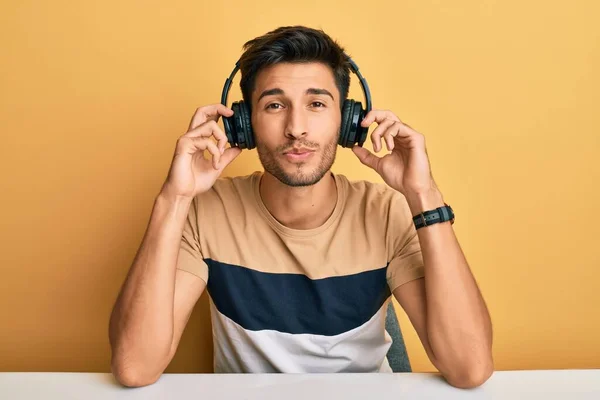 Young Handsome Man Listening Music Wearing Headphones Looking Camera Blowing — Stock Photo, Image