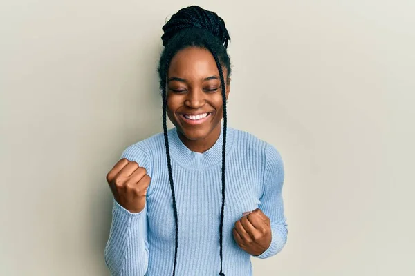 African American Woman Braided Hair Wearing Casual Blue Sweater Celebrating — Stock Photo, Image