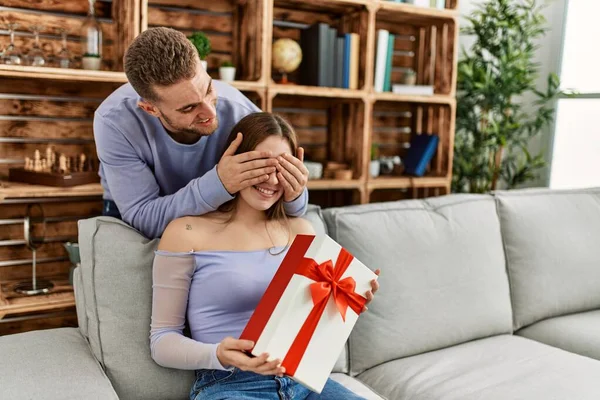 Young Man Surprising His Girlfriend Birthday Gift Home — Stock Photo, Image