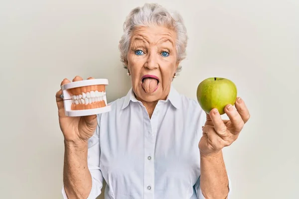 Senior Grey Haired Woman Holding Green Apple Denture Teeth Sticking — Stock Photo, Image