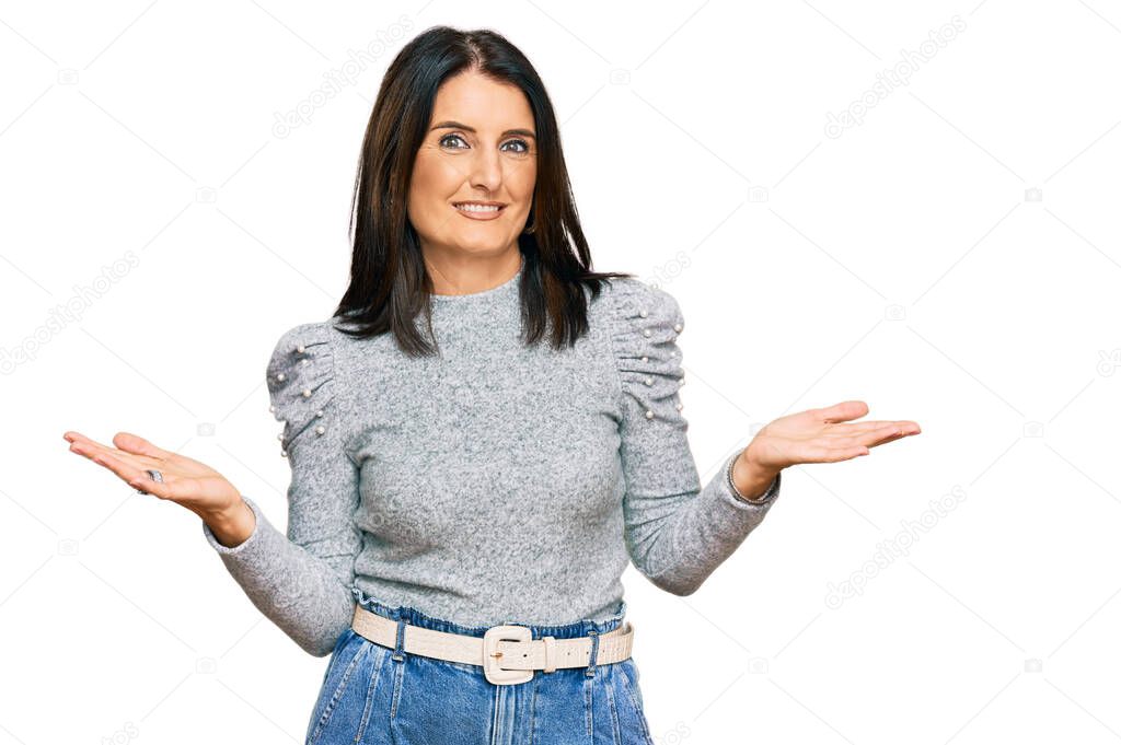 Middle age brunette woman wearing casual clothes clueless and confused expression with arms and hands raised. doubt concept. 