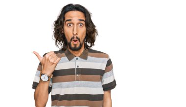 Gündelik giysiler giyen genç İspanyol adam elleri yana doğru işaret ederek şaşırdı, ağzı açık hayret içinde kaldı.. 