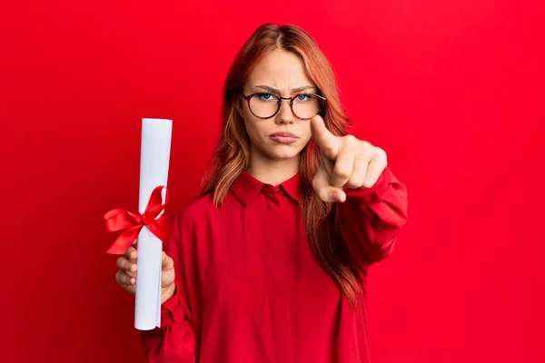 Young Redhead Woman Holding Graduate Degree Diploma Pointing Finger Camera — Stock Photo, Image