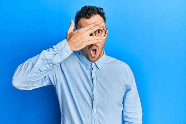 Young Hispanic Man Wearing Casual Clothes Glasses Peeking Shock Covering — Stock Photo, Image