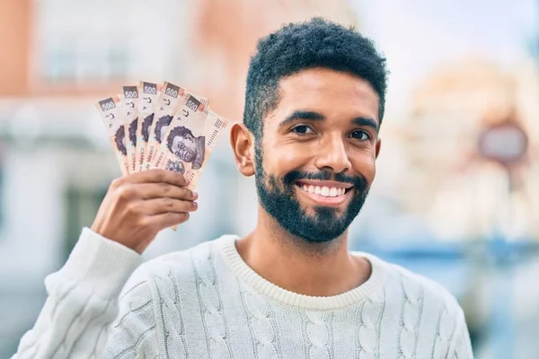 Joven Afroamericano Sonriendo Feliz Sosteniendo Billetes Mexicanos 500 Pesos Ciudad —  Fotos de Stock