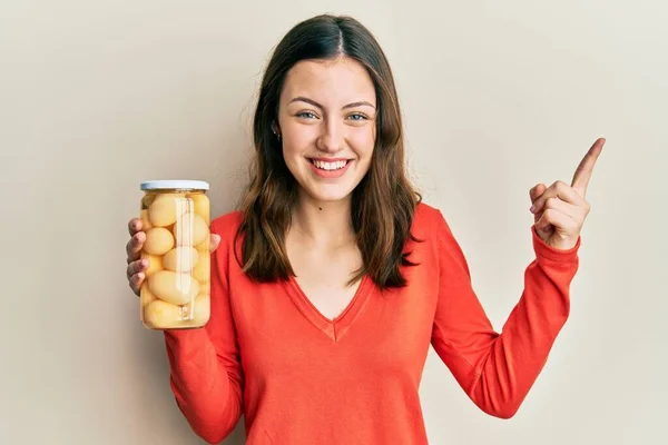 Young Brunette Woman Holding Bottle Boiled Potatoes Smiling Happy Pointing — Stock Photo, Image