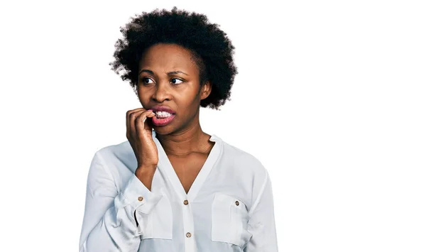 アフリカ系アメリカ人の女性は 口の爪をかむ上で手でストレスと緊張を見てカジュアルな白いTシャツを着てアフロの髪を持つ 不安の問題 — ストック写真