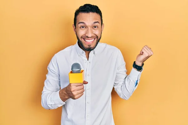 Homem Hispânico Com Barba Segurando Microfone Repórter Gritando Orgulhoso Celebrando — Fotografia de Stock