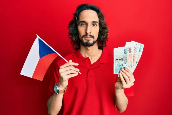 Joven Hombre Hispano Sosteniendo Bandera República Checa Billetes Corea Relajado —  Fotos de Stock