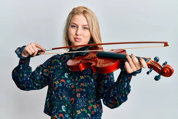 Young Blonde Woman Playing Violin Puffing Cheeks Funny Face Mouth — Stock Photo, Image