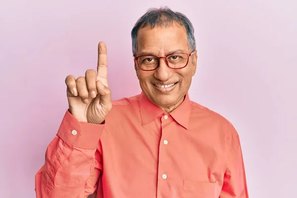 印度中年男子 身穿休闲装 戴着眼镜 带着第一指尖 面带微笑 自信而快乐 — 图库照片