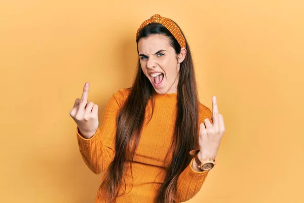 Young Brunette Teenager Wearing Casual Yellow Sweater Showing Middle Finger — Photo