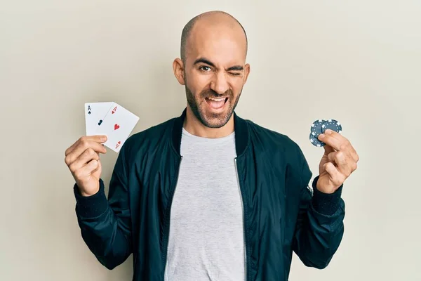 Jovem Hispânico Jogando Poker Segurando Cartas Casino Fichas Piscando Olhando — Fotografia de Stock