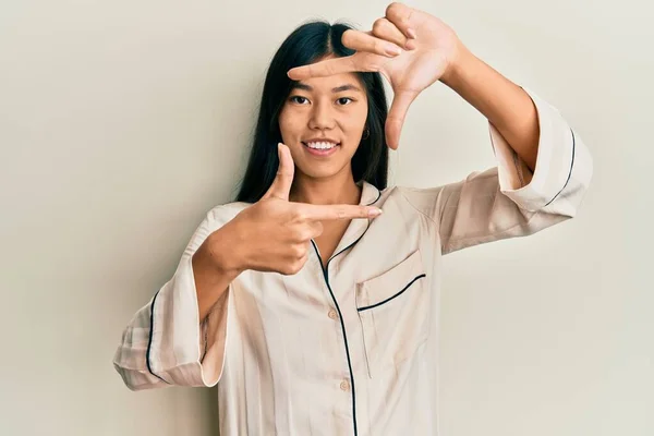 Young Chinese Woman Wearing Pajama Smiling Making Frame Hands Fingers — Stock Photo, Image