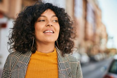 Genç İspanyol iş kadını şehirde mutlu mesut ayakta duruyor..