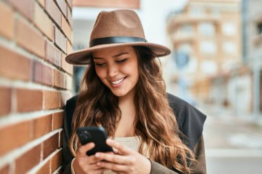 Şehirde akıllı telefon kullanan genç İspanyol turist kadın..